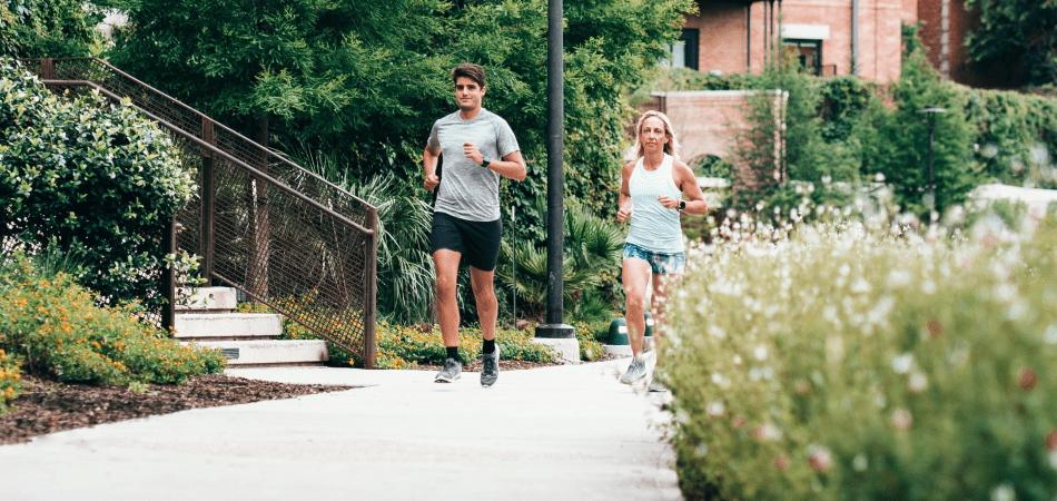 Man and woman jogging on a path in their neighbourhood