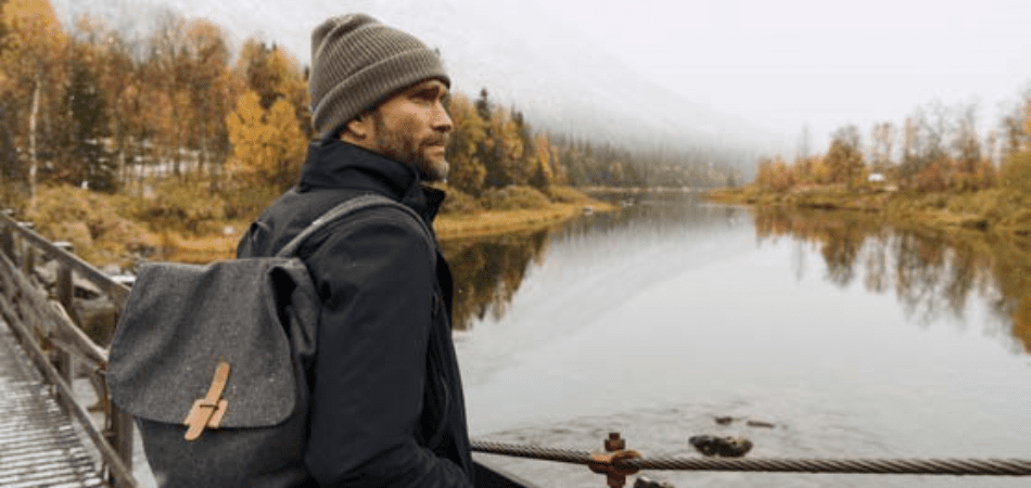 Sustainable wool backpack on mans shoulder